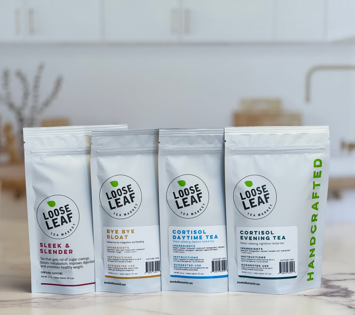 Four Loose Leaf Tea Market tea pouches on a marble kitchen counter
