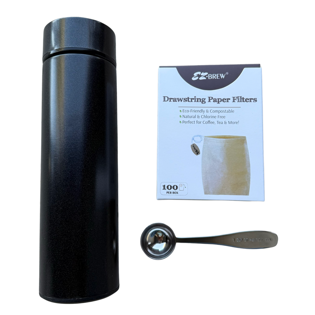 A stainless steel tea tumbler, measuring teaspoon, and a package of drawstring paper tea filters.